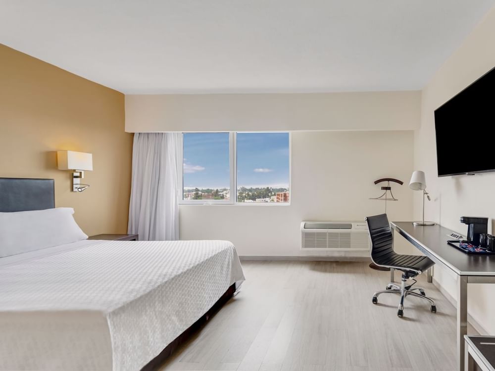 Comfy king bed in Superior Room at Fiesta Inn Hotels