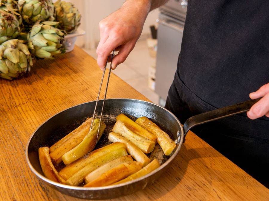 A man preparing Maple roasted parsnips at The Originals Hotels
