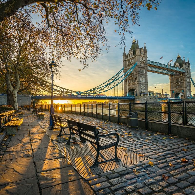 Autumn morning by the Thames, featuring Tower Bridge, and benches near Warwick Hotels and Resorts