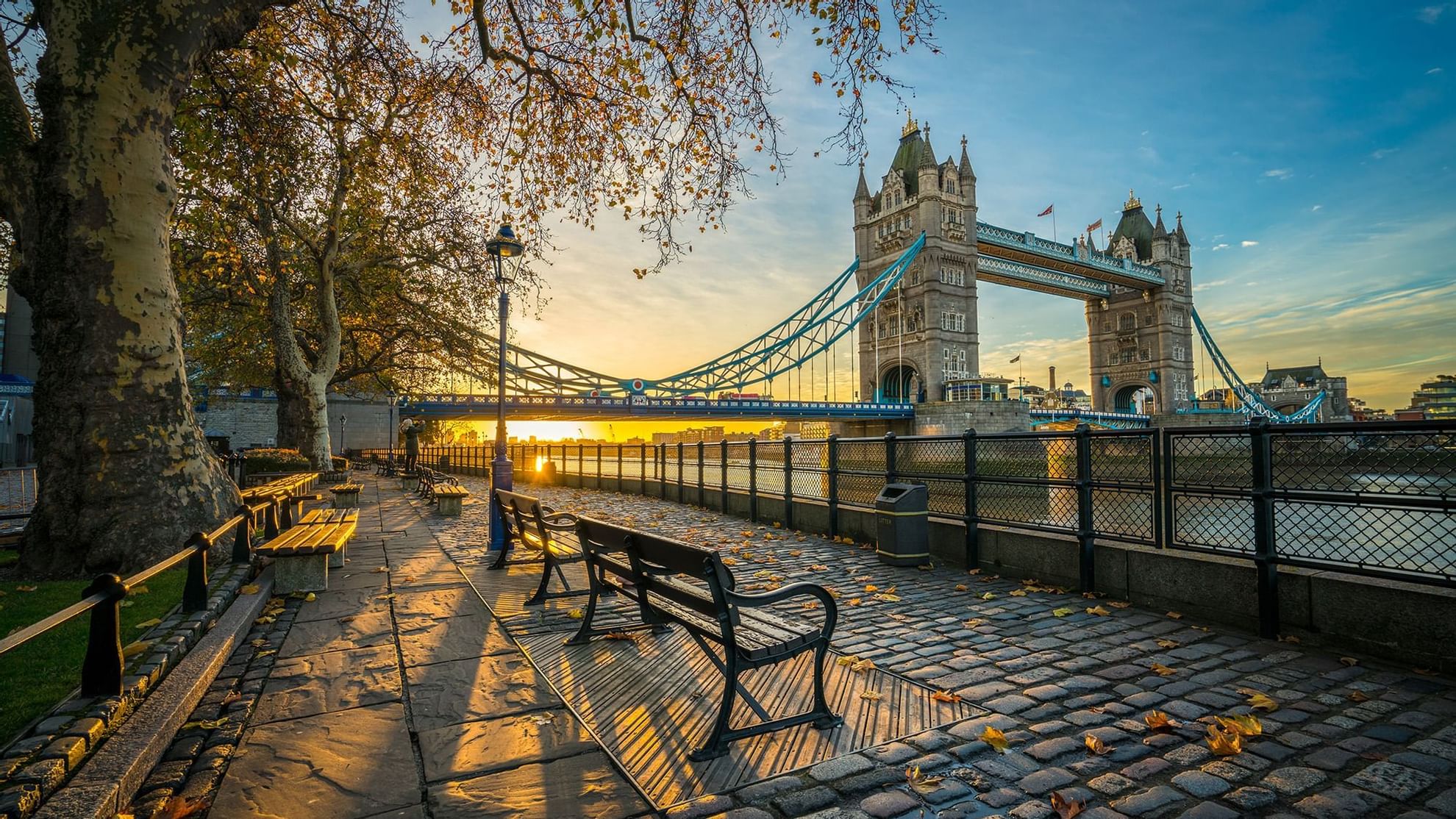 Autumn morning by the Thames, featuring Tower Bridge, and benches near Warwick Hotels and Resorts