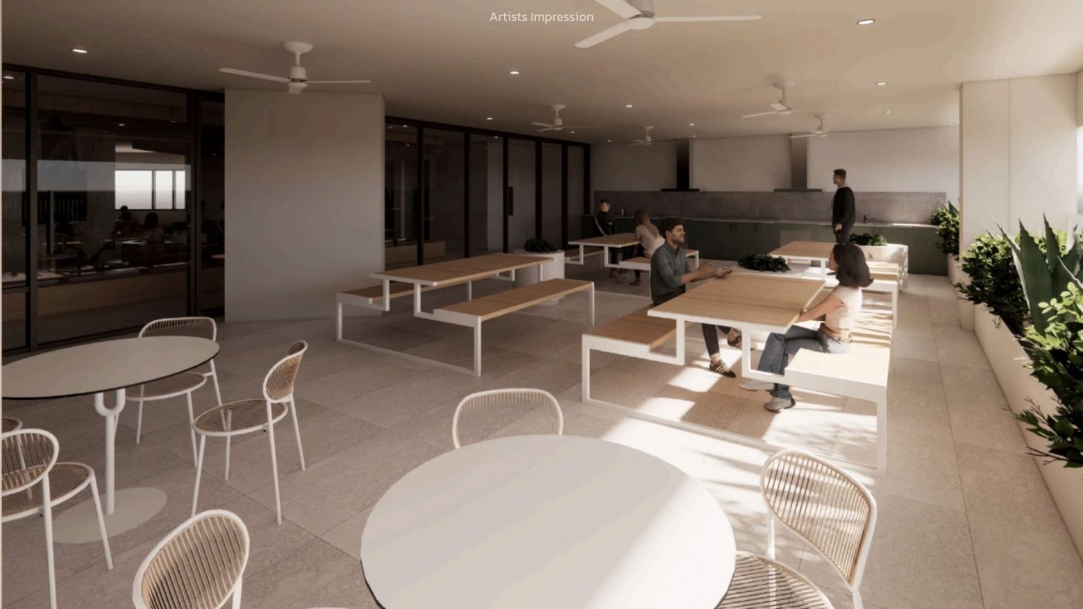 People sitting and standing in a communal space with tables and chairs at UniLodge Brisbane City.