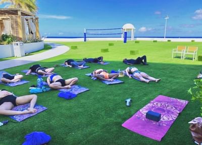 Guests doing yoga outdoors, The Morgan Resort Spa Village