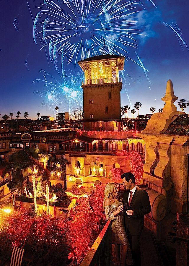 Couple on a balcony & fireworks on sky at Mission Inn Riverside