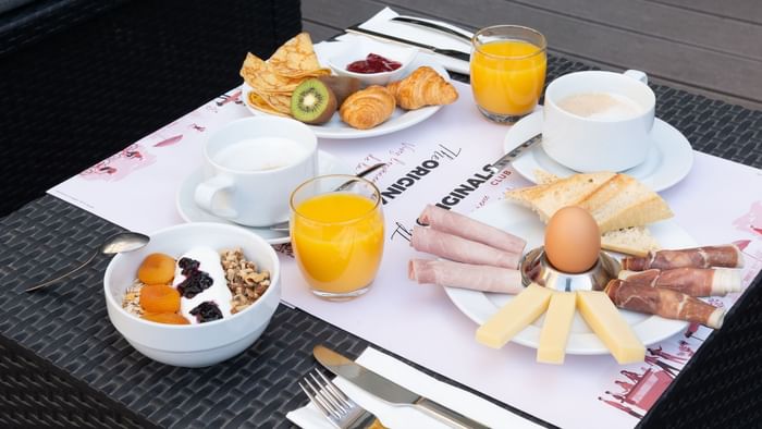 Close-up of breakfast served on a table at The Originals Hotels