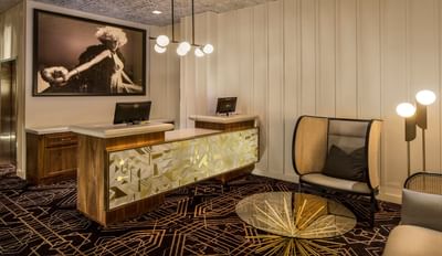 Lobby lounge area with a reception desk and carpeted floors at Hotel Bijou, one of the best boutique hotels in San Francisco