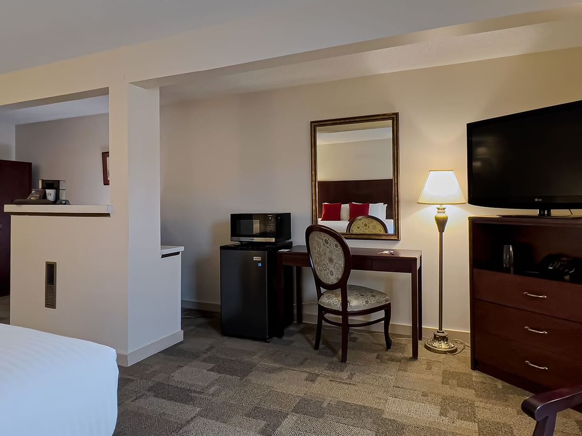 Guest room with king bed, tv, chair