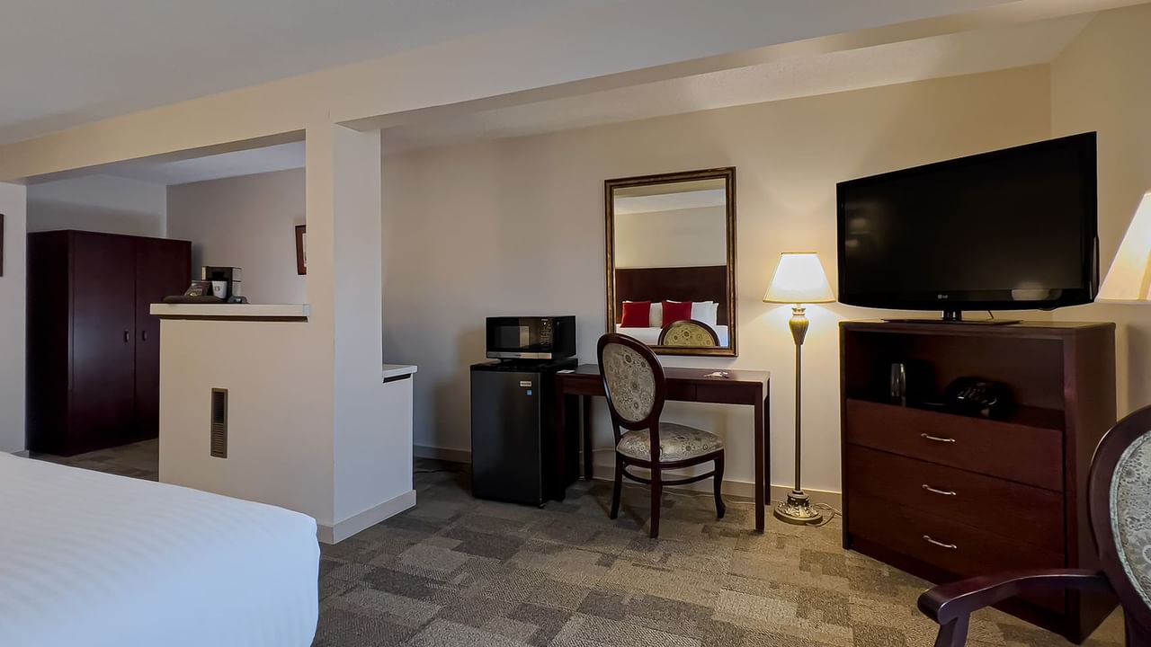 Guest room with king bed, tv, chair
