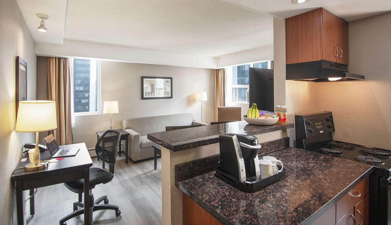 Hotel suite with a living area and a kitchen area