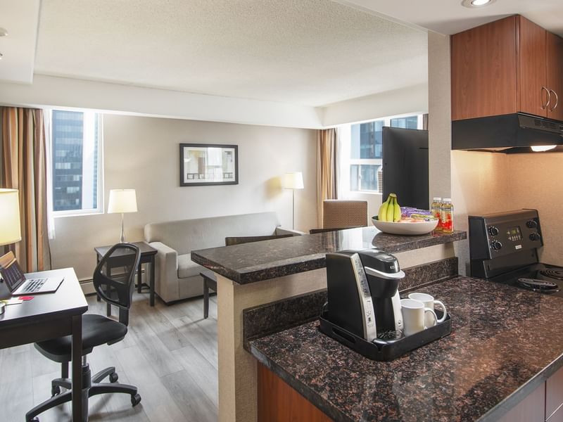 Hotel suite with a living area and a kitchen area