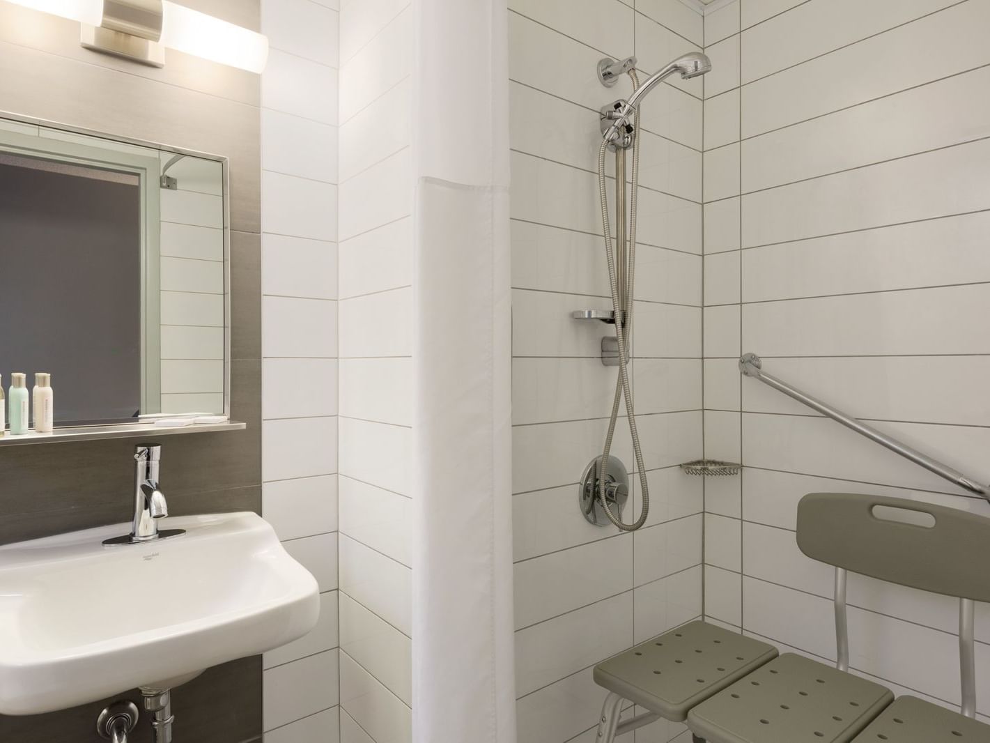 Bathroom with shower & shower seat in Accessible Room at Travelodge Montreal Centre