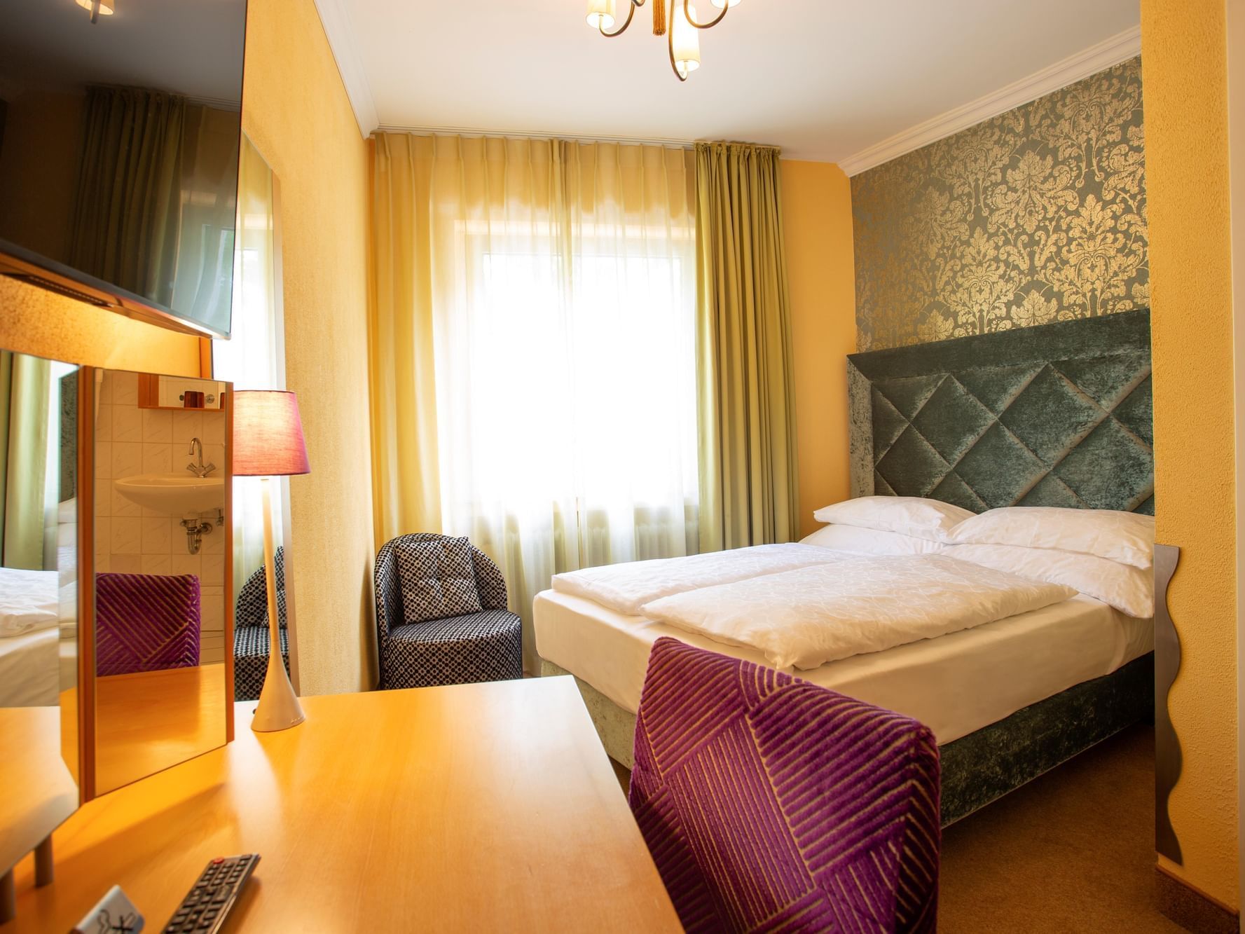 Table, stylish furniture and a double in Economy Double Room at Classic Harmonie Koln