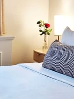 Close-up of bed with flower vase on the side table in Standard Room at Warwick Allerton Chicago