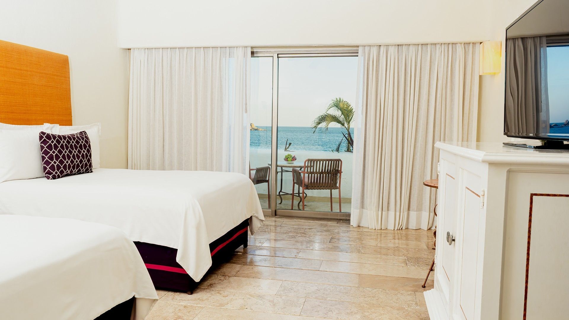 Side cupboard facing the cozy beds in Two Double Deluxe with private balcony seating at Camino Real Zaashila Huatulco