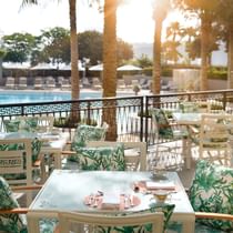 Outdoor dining area by the pool in Giardino at Palazzo Versace