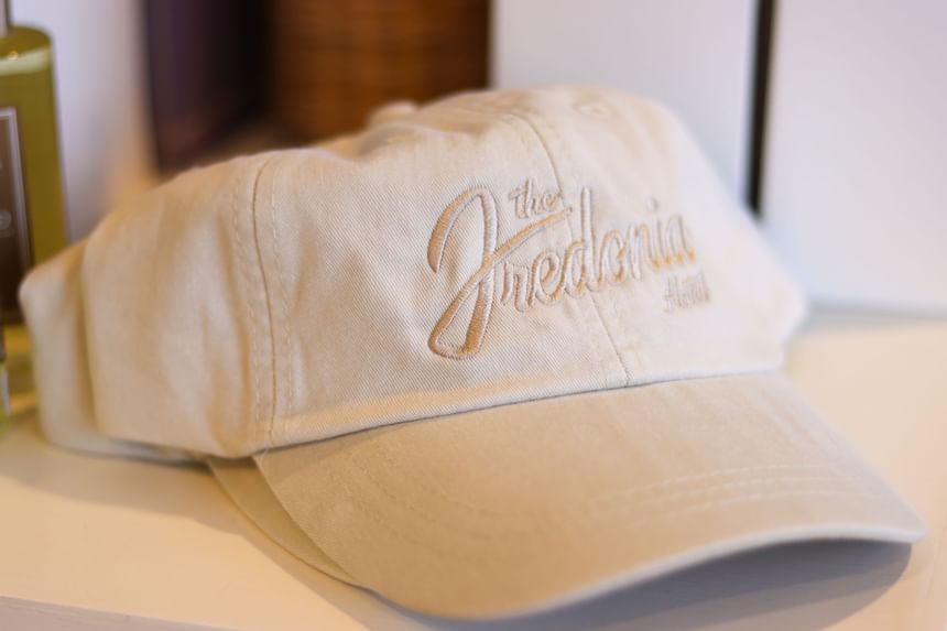 A white baseball cap displayed in the giftshop at The Fredonia Hotel