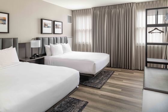 Two beds with cushioned headboards in a cozy room at Portland Harbor Hotel