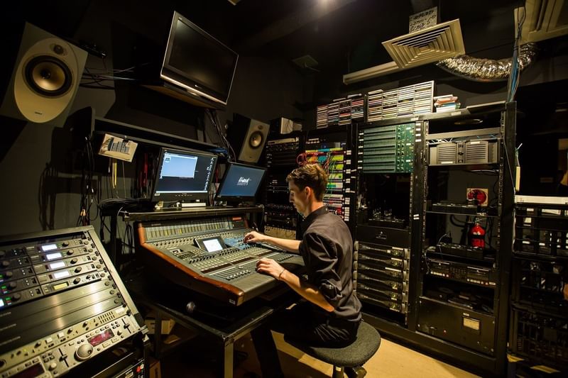 Sound engineer fine-tuning a mixer at Sofitel Sydney Wentworth