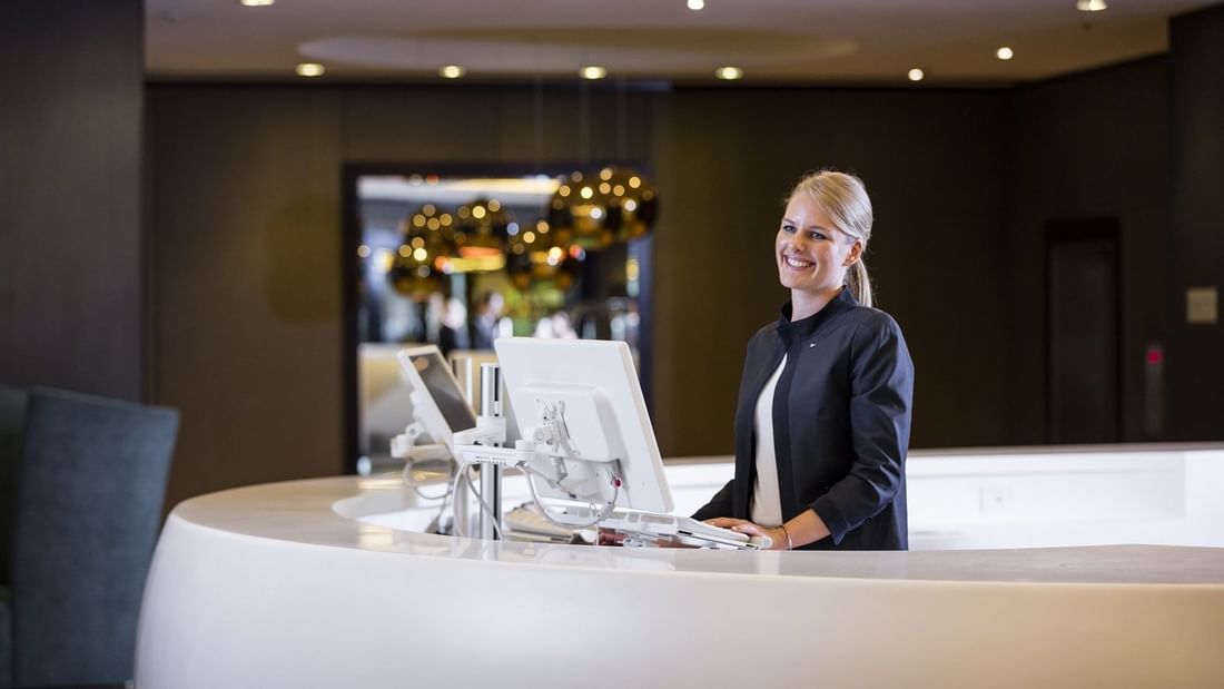 Receptionist by the front desk at Pullman & Mercure Brisbane King George Square
