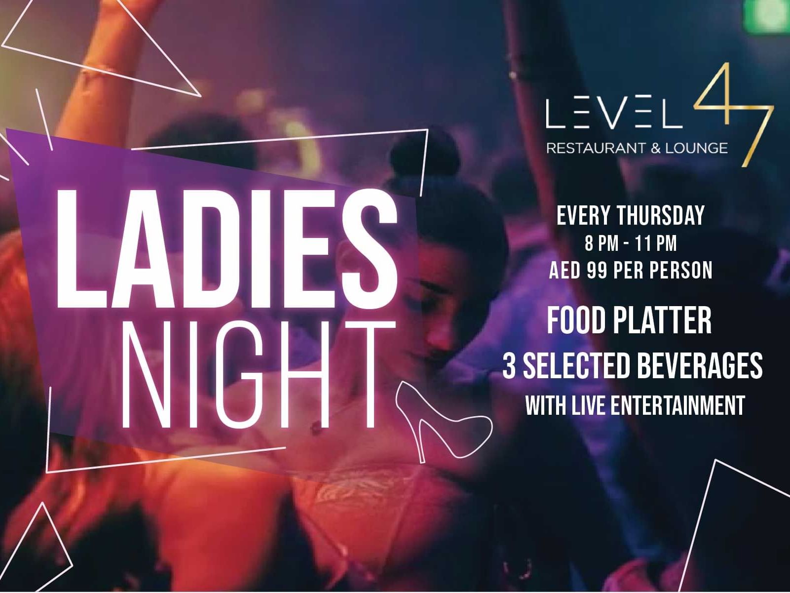 Women enjoying drinks and food with city lights and live music at Level 47 rooftop.
