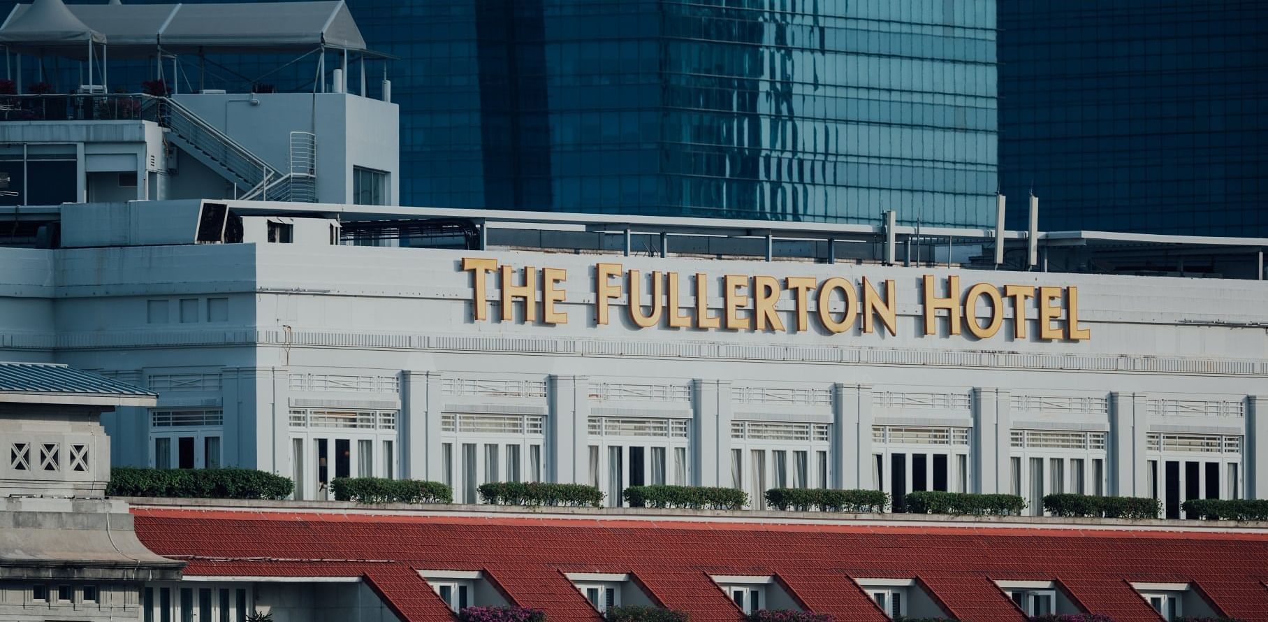 Facade of the name board of The Fullerton Hotel