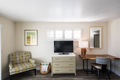 a tv and chair in a hotel room