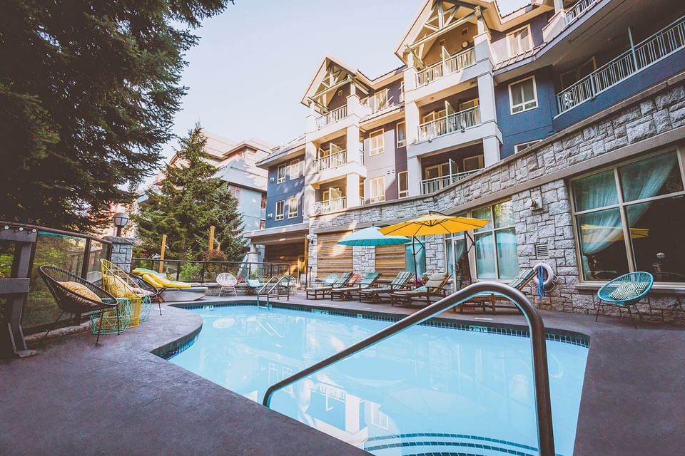 Sunbeds by the outdoor pool at Summit Lodge
