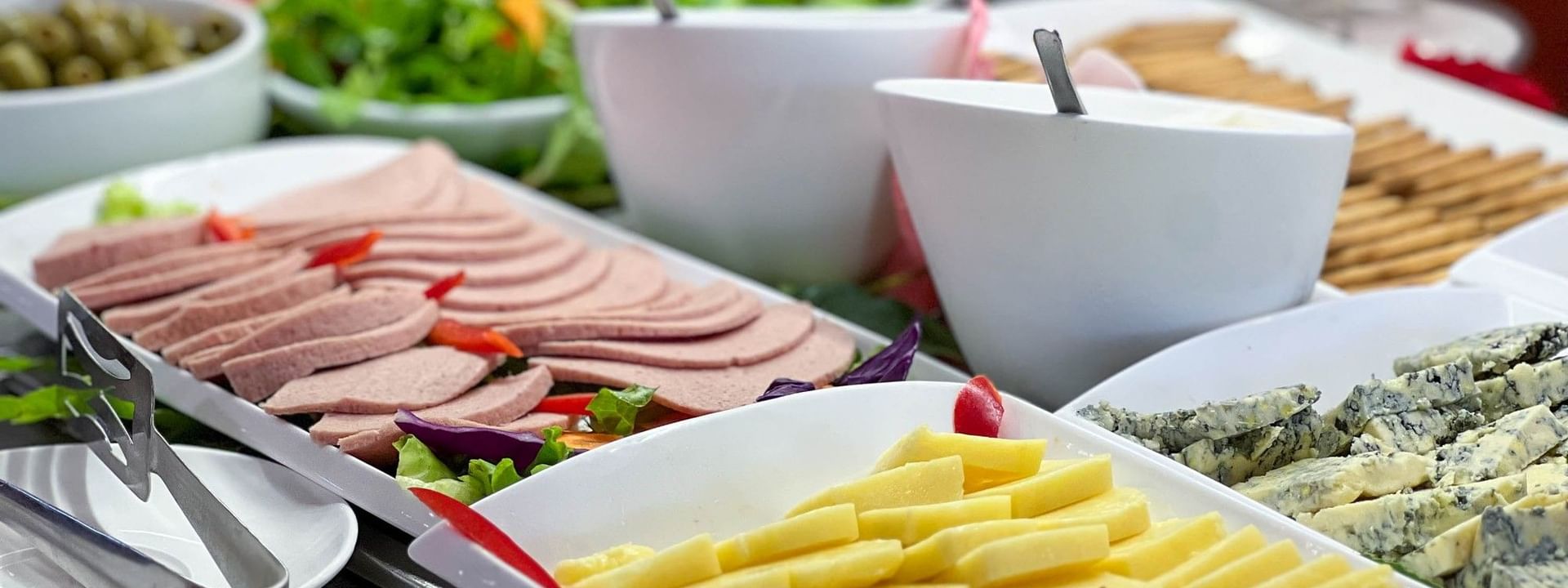 Variety of sliced cheeses and meats on plates at Nukunuku Restaurant & Bar in The Naviti Resort - Fiji