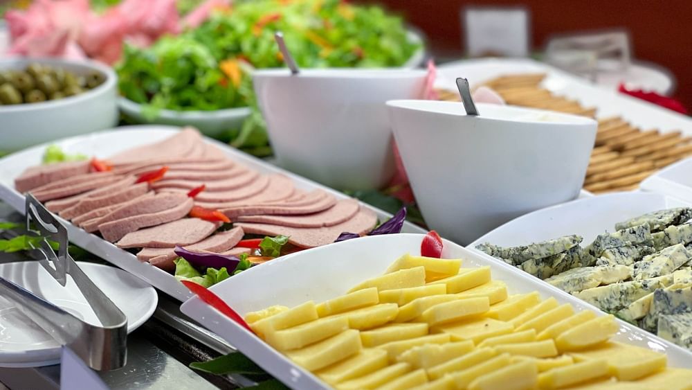 Variety of sliced cheeses and meats on plates at Nukunuku Restaurant & Bar in The Naviti Resort - Fiji.