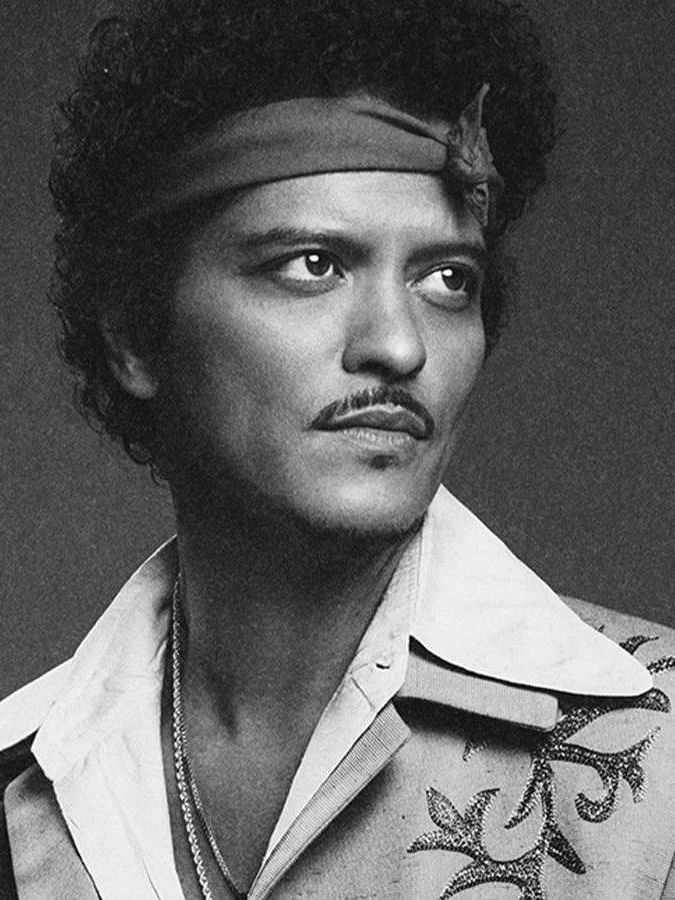 Black and white picture of Bruno Mars staring into the distance