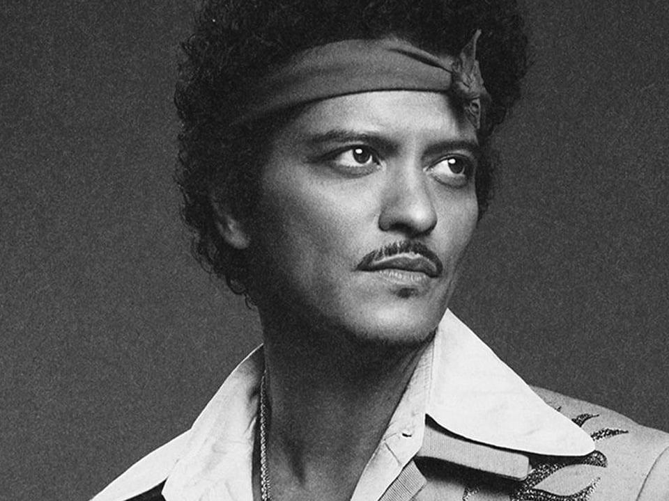 Black and white picture of Bruno Mars staring into the distance