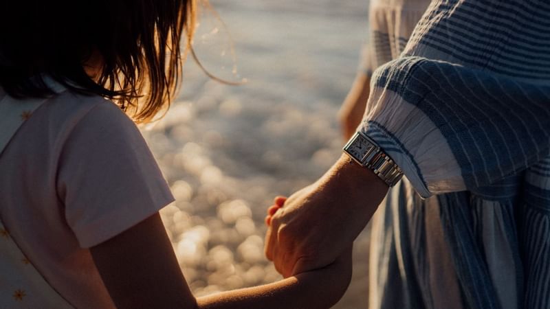 Close up on mother holding her daughter's hand at crown hotels