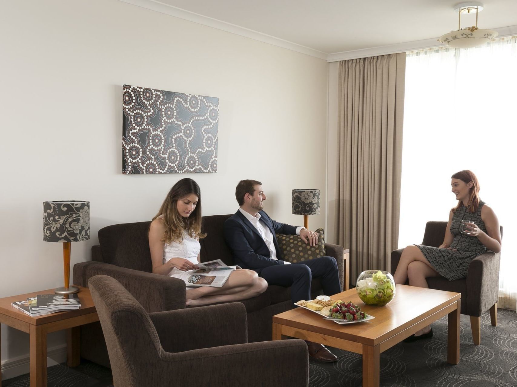 Men discussing in the  sitting area at the Sebel Residence Chatswood