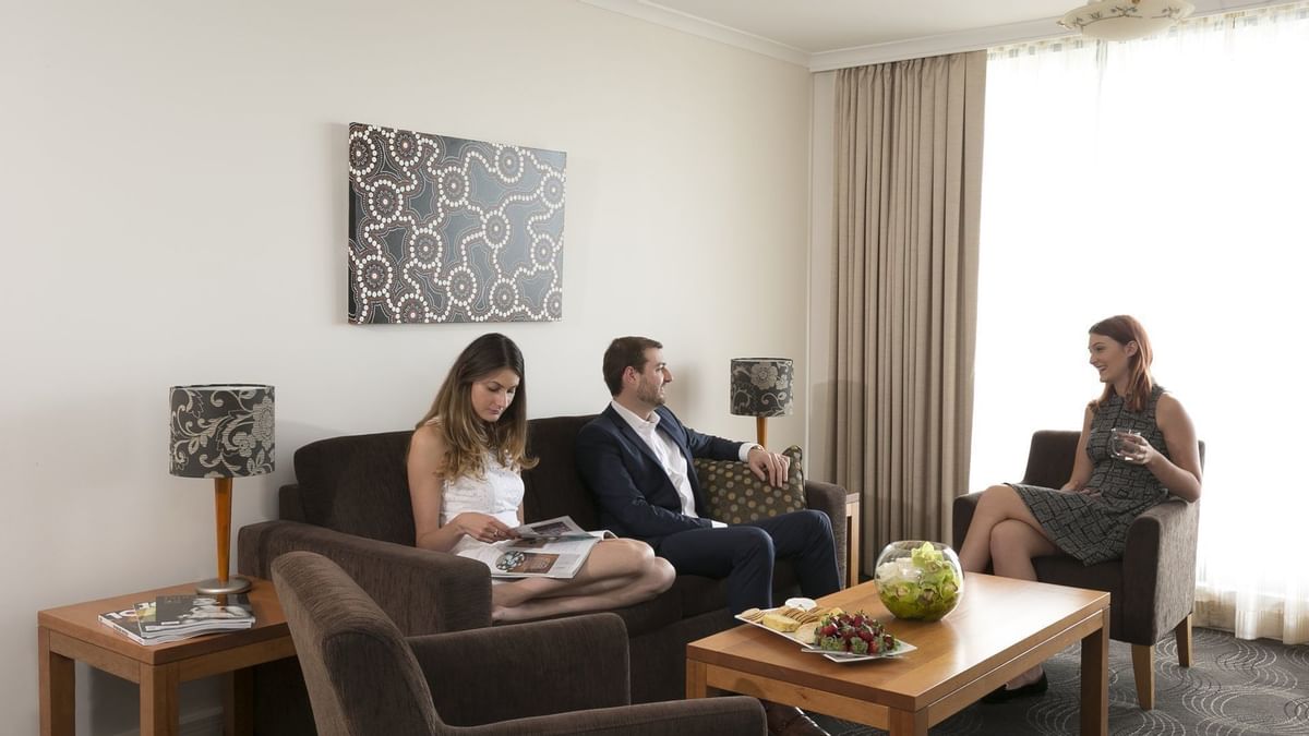 Men discussing in the  sitting area at the Sebel Residence Chatswood