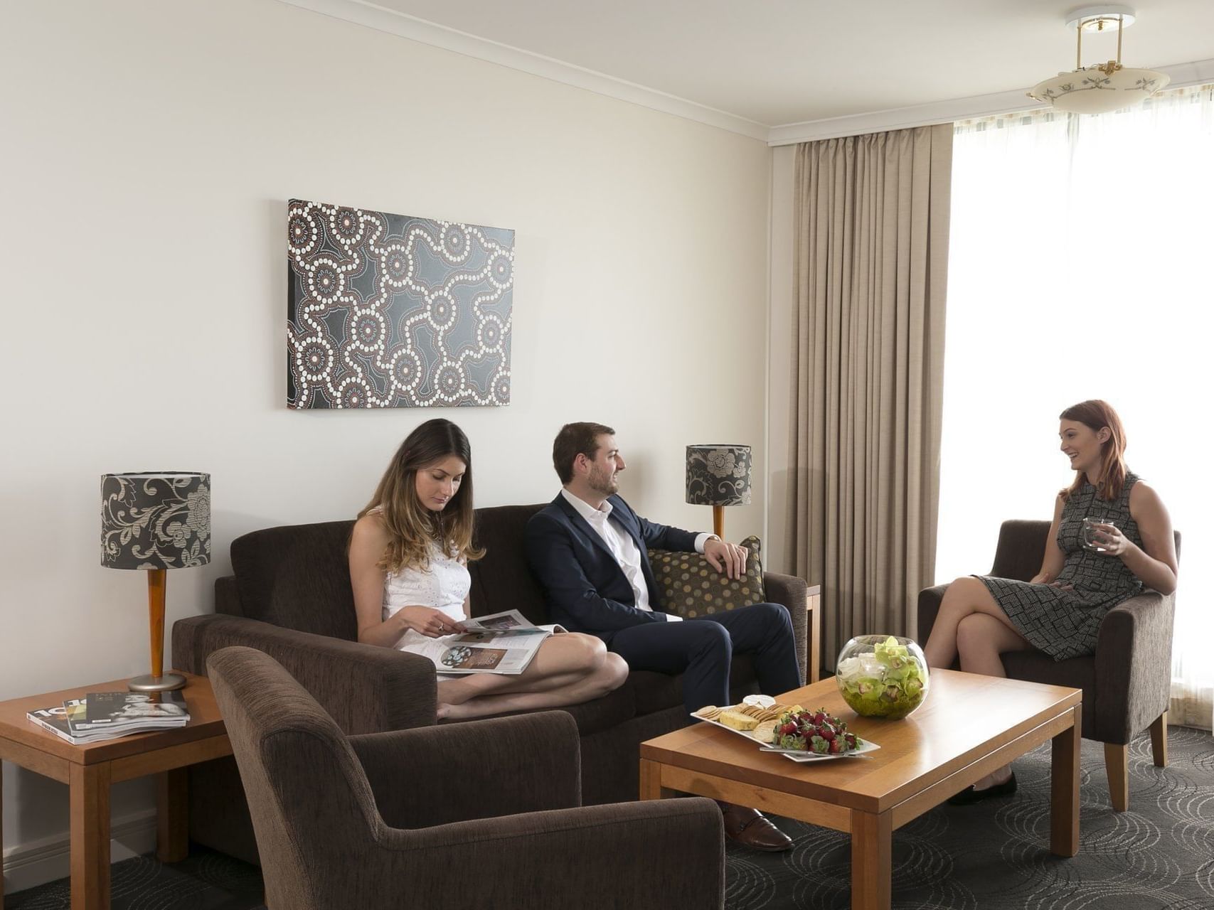Men discussing in the sitting area at the Sebel Residence Chatswood