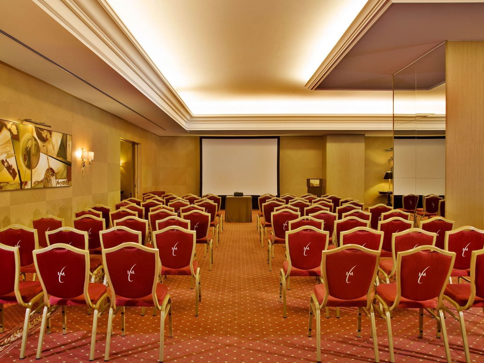 Room with alot of red and gold chairs at Hotel Cascais Miragem