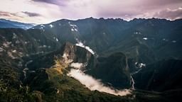 Landscape of a mountain range and morning mist at Hotel Sumaq