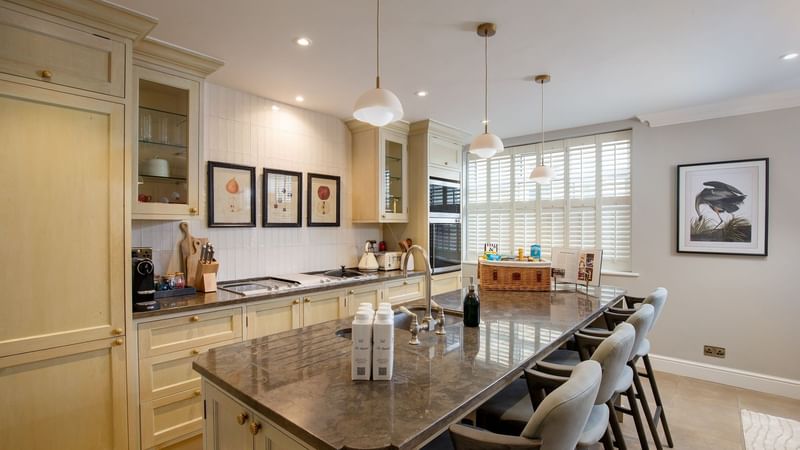 Modern kitchen with marble island and breakfast bar in a Three Bedroom Penthouse at The Capital Hotel, Apartments & Townhouse London.