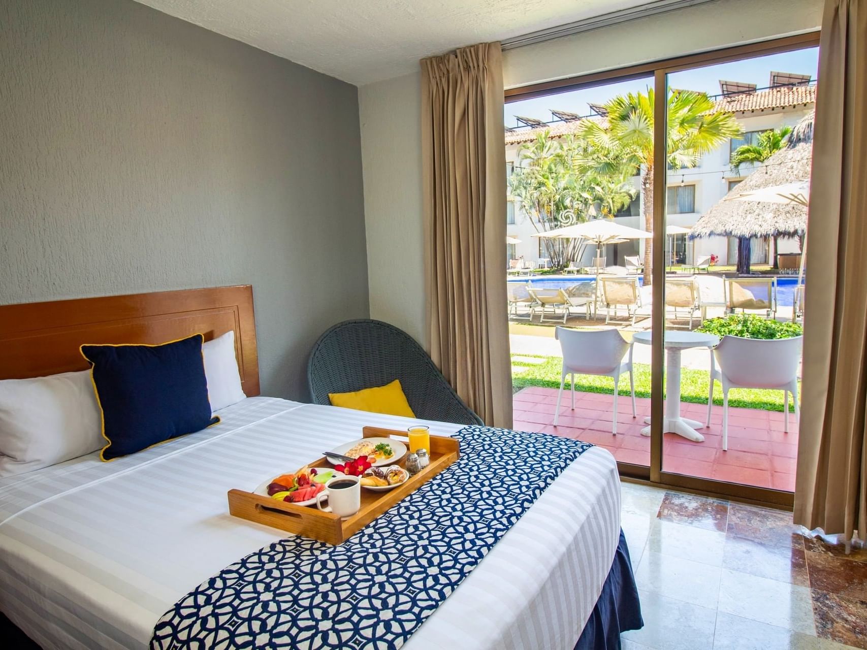 Breakfast served on the bed and outside view from the room in Plaza Pelicanos Club Beach Resort