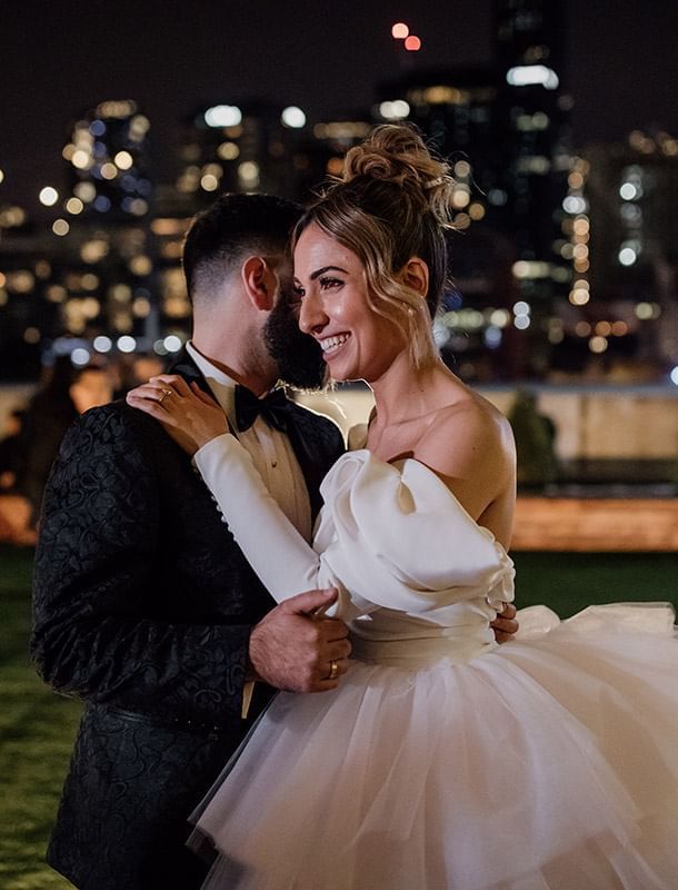 Happy wedded couple dancing, smiling at Crown Hotel Melbourne