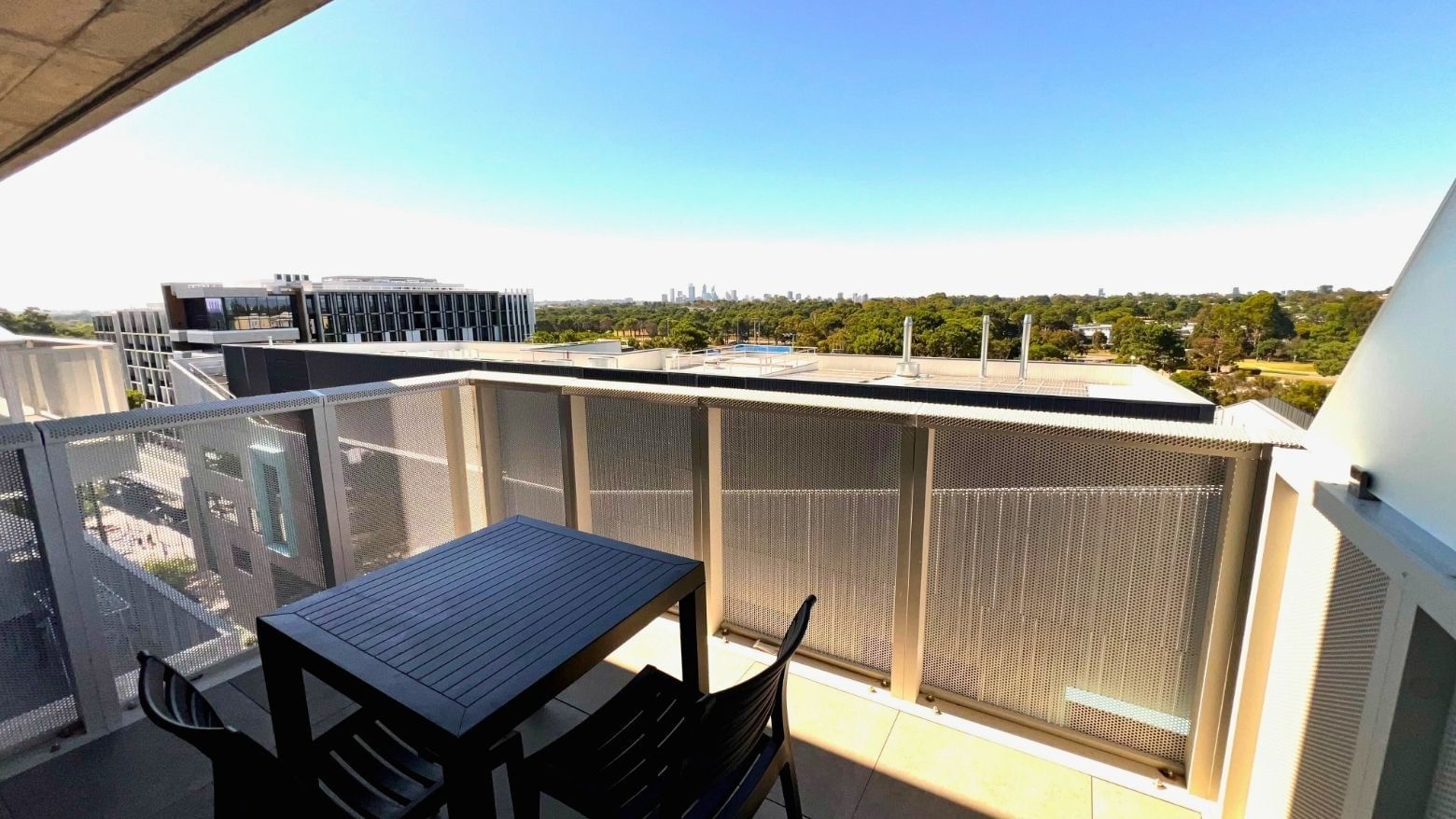 Balcony with table and chairs at UniLodge at Curtin University - Zamia Apartments.