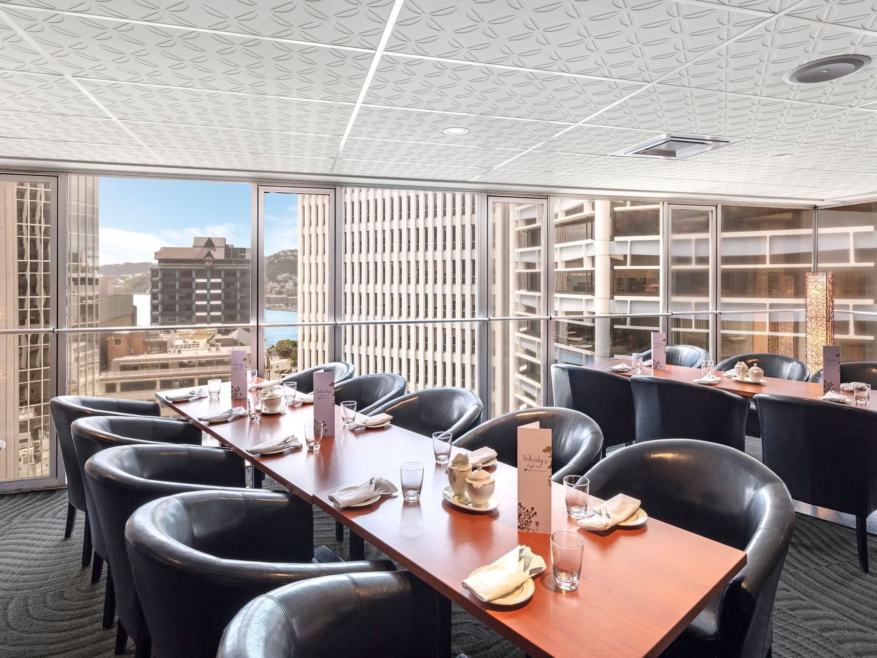 Long dining tables in a restaurant at James Cook Grand Chancellor
