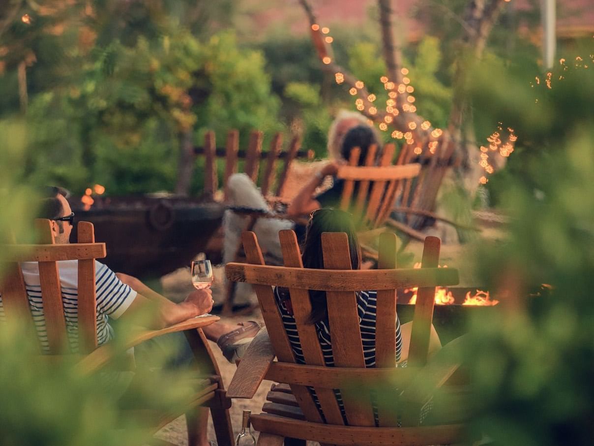 Guests sitting on lawn chairs in garden