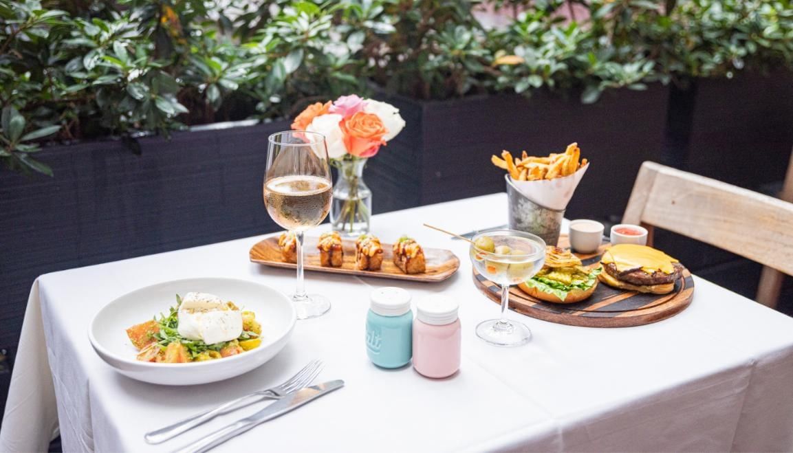 A table set with food and wine in an outdoor dining area