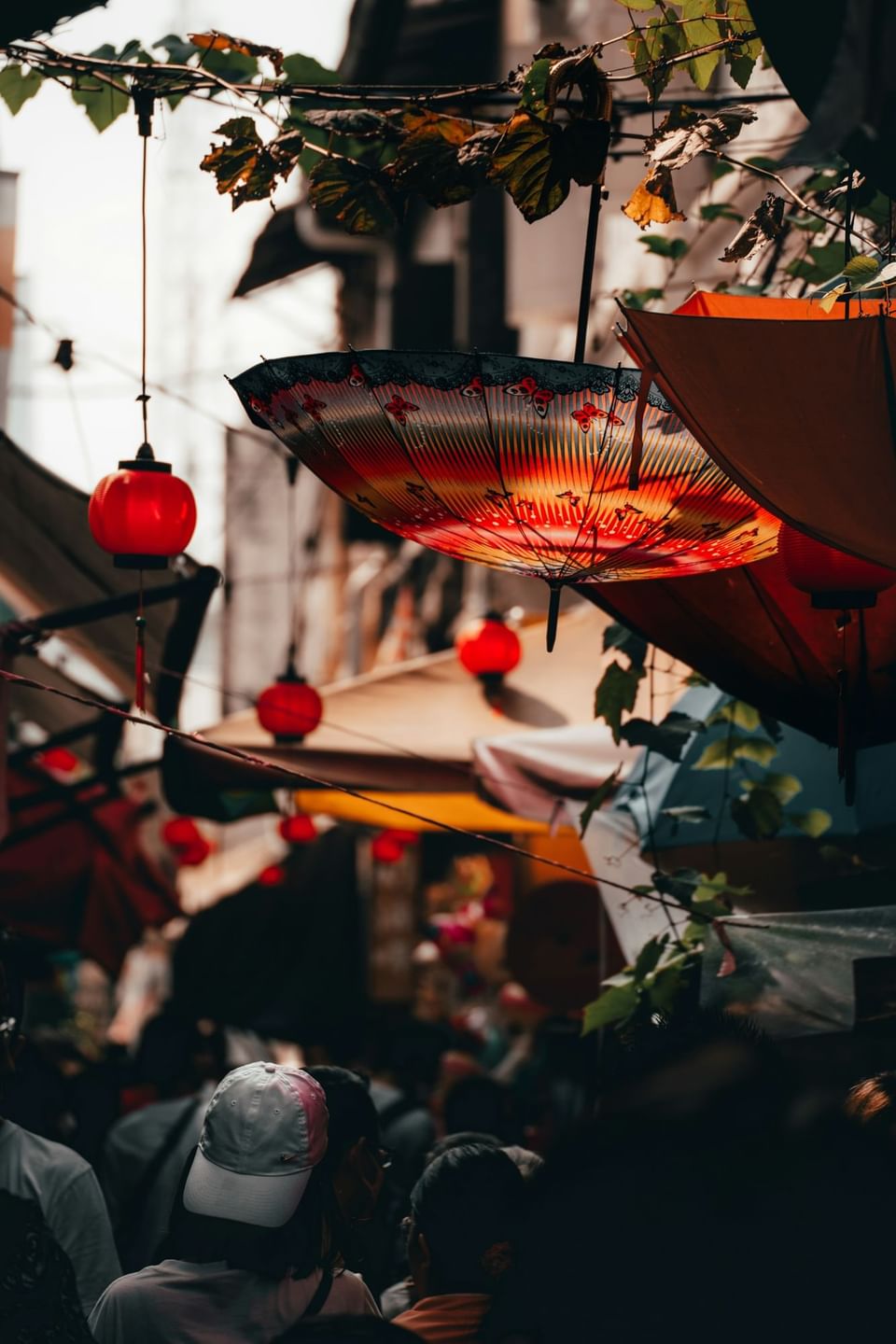 Decorative umbrellas and lanterns hanging in narrow alleyways near The Terraces Resort & Spa
