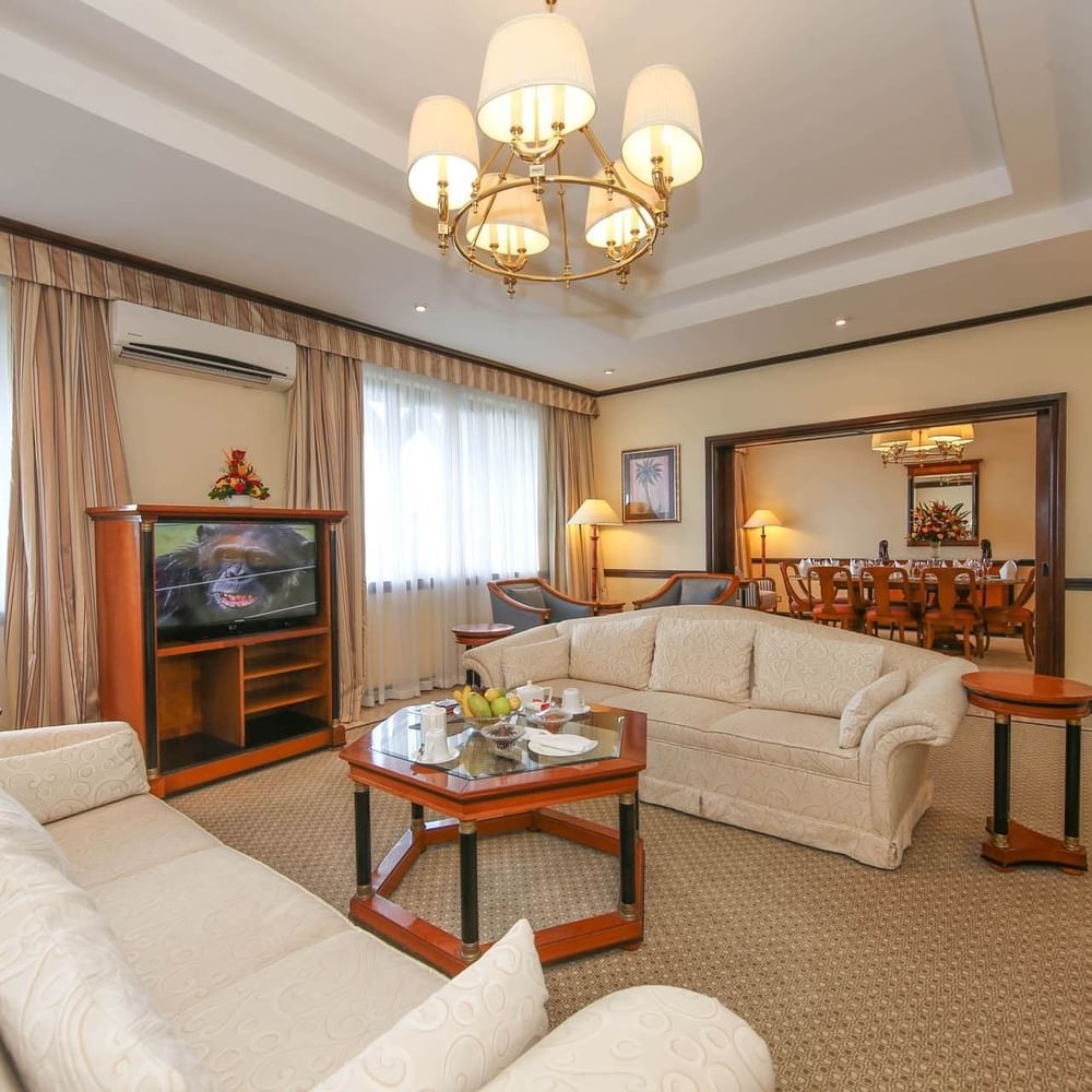 Elegantly furnished Presidential Suite living area with sofas, coffee table, and chandelier at Dar Es Salaam Serena Hotel.