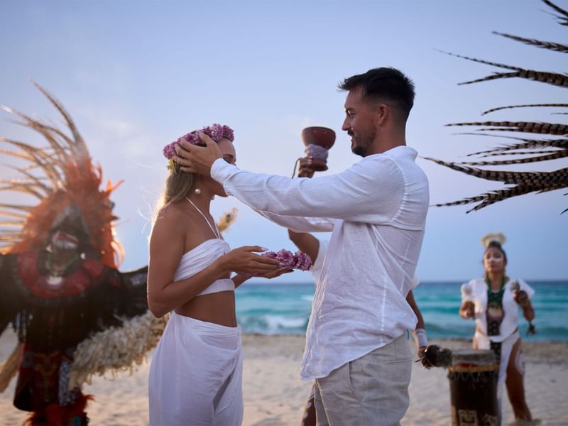 Beach wedding in Cancun with a happy couple exchanging vows at Fiesta Americana