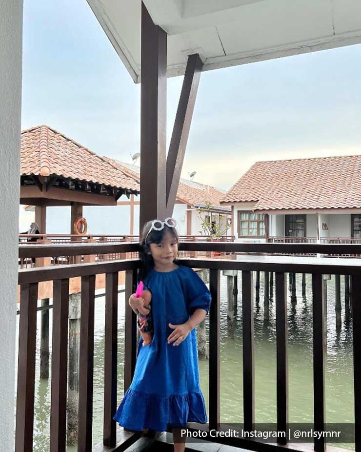 a kid wearing a blue dress while holding a toy at the water chalet - Lexis PD