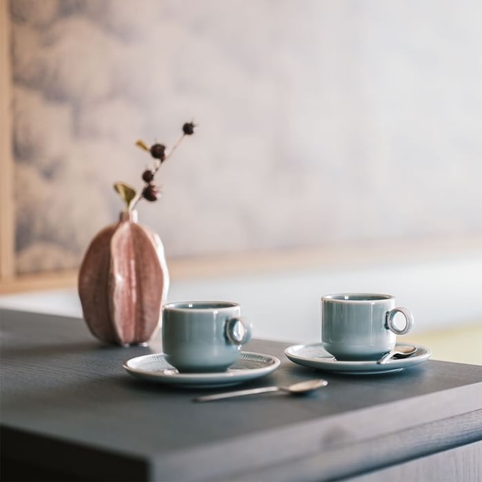 Two coffee cups and vase on a table at Falkensteiner Hotel Montafon