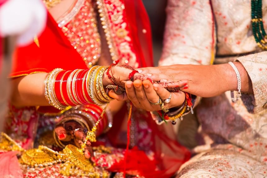 Bride and groom exchange rings in a traditional ceremony at APA Hotel Woodbridge.