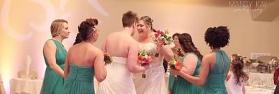 Joyous moment with the brides and the bridesmaids dancing together at Lake Natoma Inn